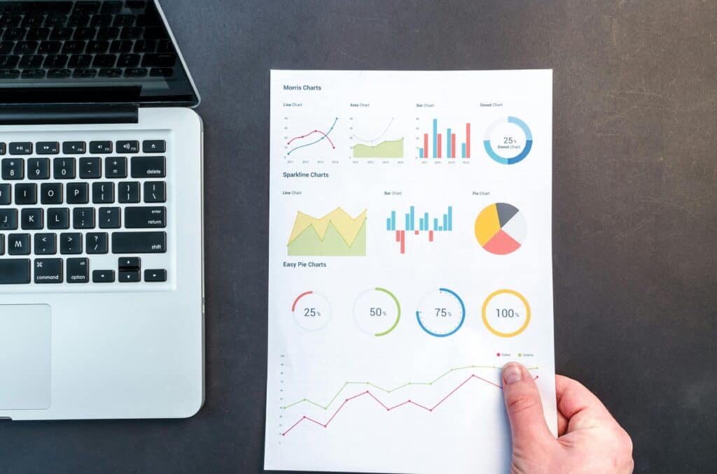 Analytics dashboard illustration for small business websiteAnalytics dashboard illustration for small business websiteAnalytics dashboard illustration for small business website.Detailed charts and graphs on a document next to a laptop, representing data analysis.